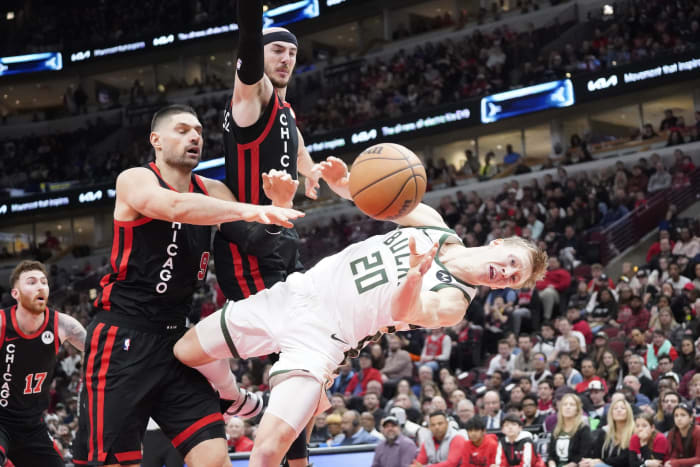 Chicago Bulls center Nikola Vucevic (9) flagrantly fouls Milwaukee Bucks guard AJ Green (20)